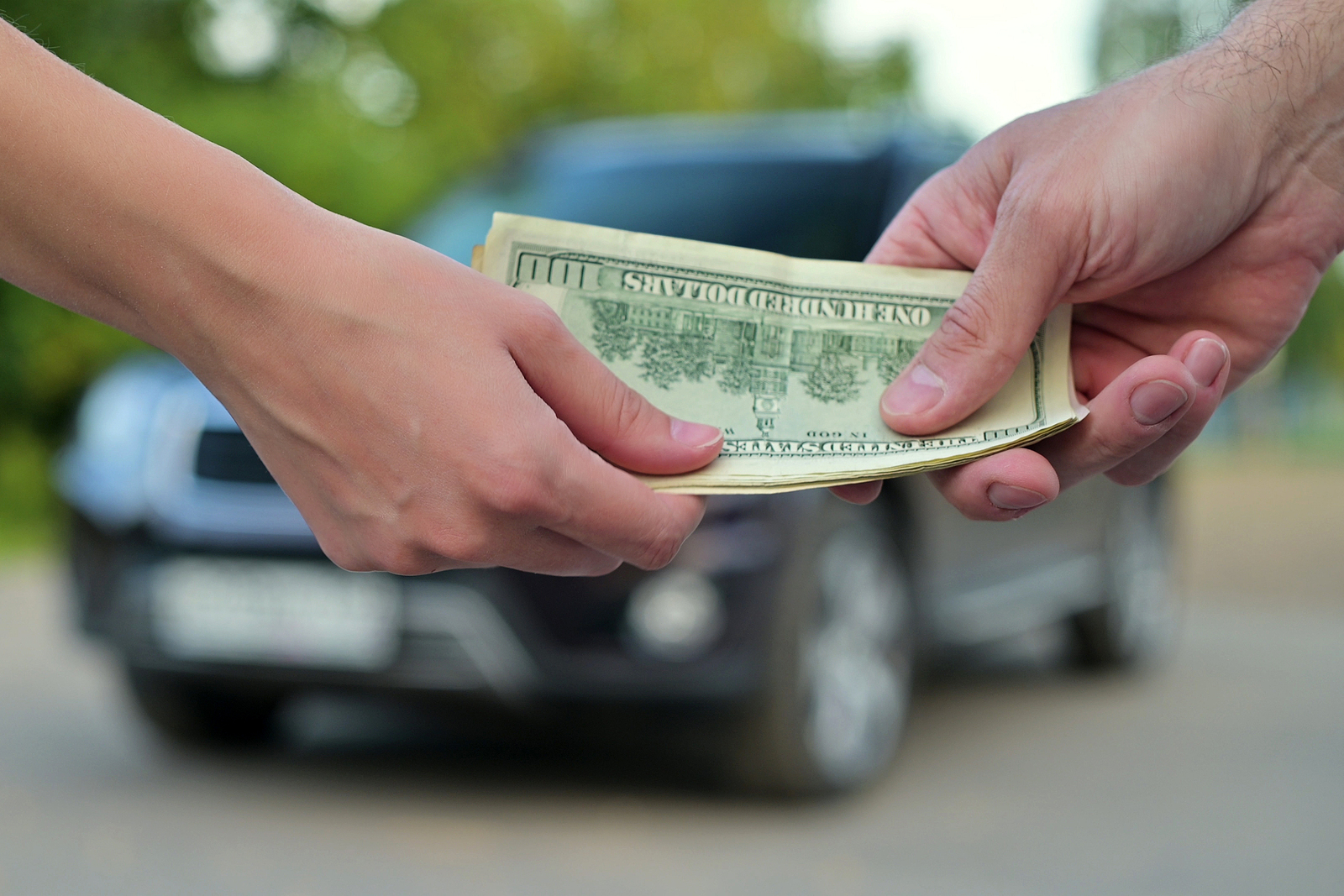 Handing over cash for a car